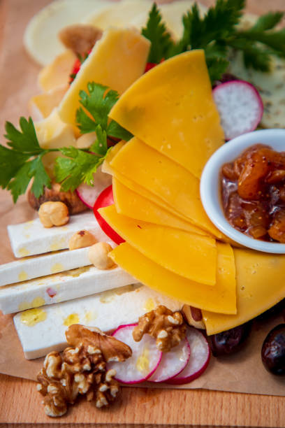 istock Cheese delicatessen appetizer on wooden board in fine dining 1533418880