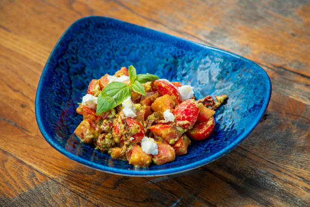 istock Appetizer salad in bowl, cherry tomato in pesto sauce with curd cheese 1533422292