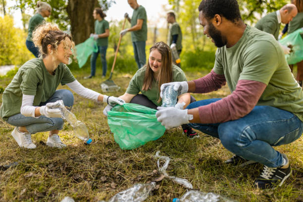 istock Group of volunteers collecting trash in a forest 1533430282