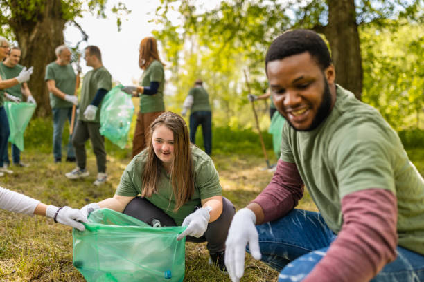 istock Group of volunteers collecting trash in a forest 1533430820
