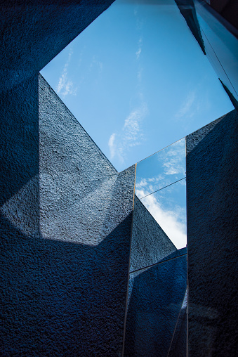 Barcelona, Spain - 06 08 2022: Natural Science Museum of Barcelona, or Museu Blau, at the Forum building, designed by Swiss architects Herzog & de Meuron. Abstract architectonic detail with opening to the sky. Looking up. Blue Museum.