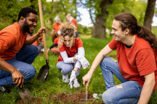istock Group of young people digging a hole for planting a tree 1533431858