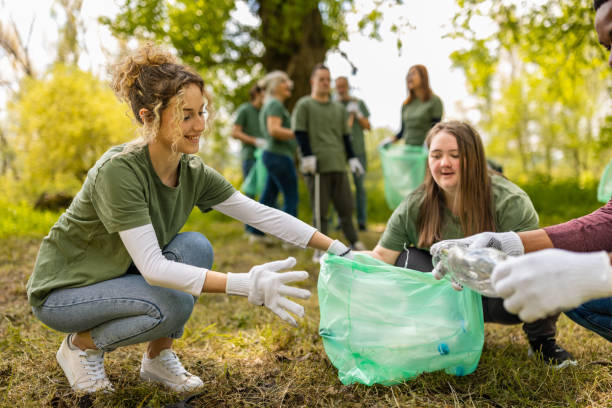 istock Group of volunteers collecting trash in a forest 1533431859