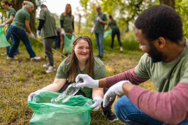 istock Group of volunteers collecting trash in a forest 1533433458