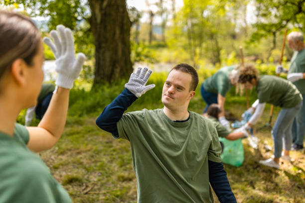 istock Volunteers high-fiving while cleaning a forest from trash 1533435050