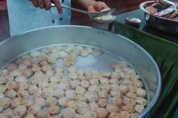 istock Nepalese steamed dumpling momo serving at the party. Close up image. 1533436112