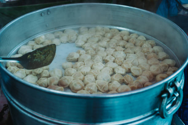 istock Nepalese steamed dumpling momo in a big Steamer pot. Close up image. 1533436275