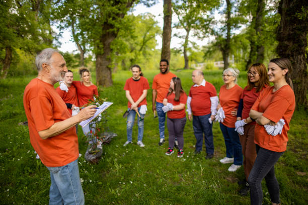 istock Senior man organizing a group of activists in a forest 1533443531