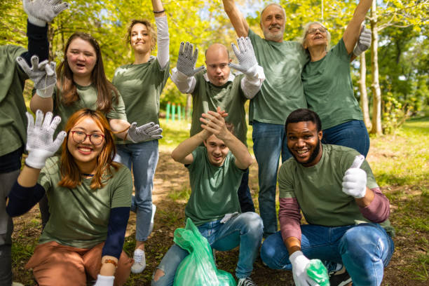 istock Volunteers waving to camera after collecting garbage in a forest 1533443532