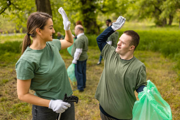 istock Volunteers high-fiving while cleaning a forest from trash 1533443539