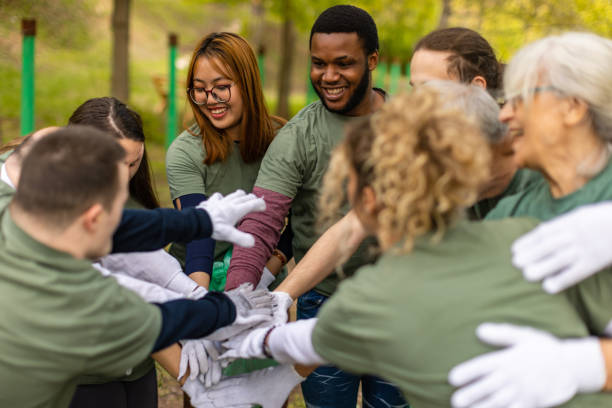 Activists uniting hands after cleaning a forest together