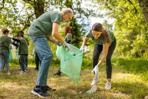 istock Group of environmentalists collecting trash in a forest together 1533459315