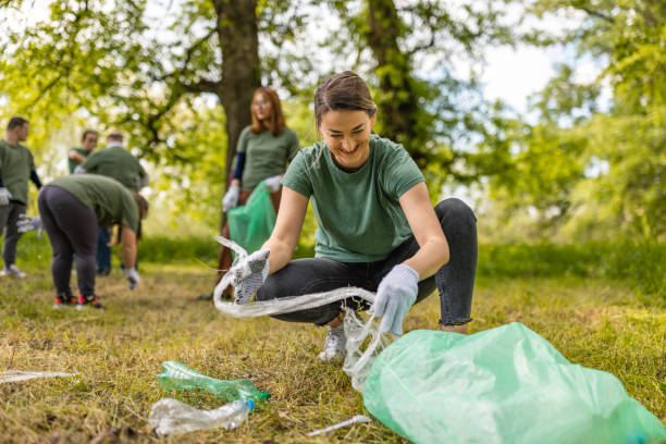 istock Group of environmentalists collecting trash in a forest together 1533459319