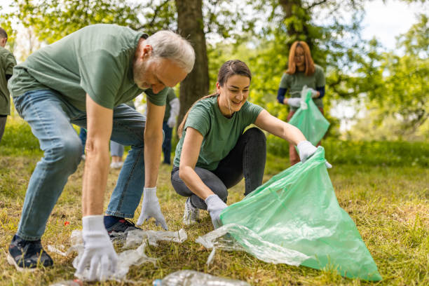 istock Group of environmentalists collecting trash in a forest together 1533459320