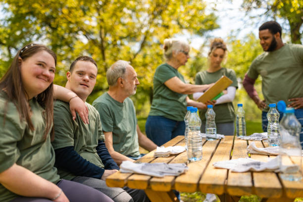 istock Group of volunteers taking a break in a rest area after a forest cleanup 1533459321