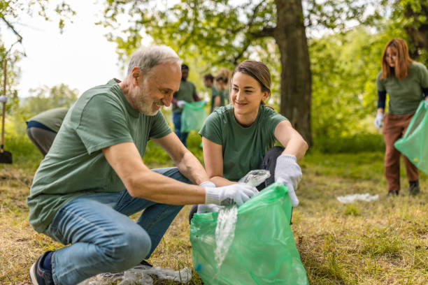 Group of environmentalists collecting trash in a forest together