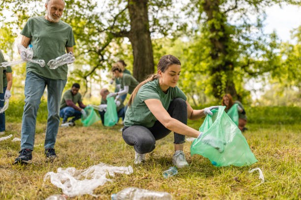istock Group of environmentalists collecting trash in a forest together 1533461993