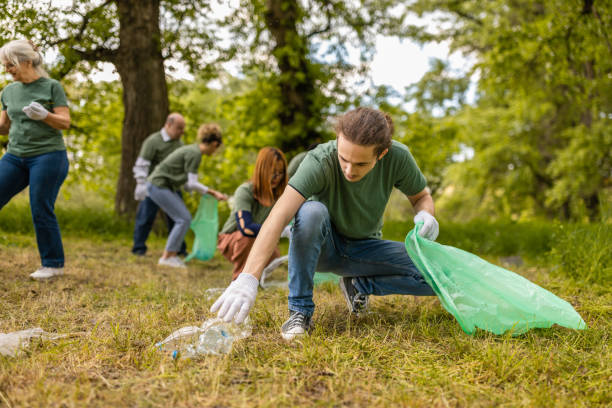 istock Group of environmentalists collecting trash in a forest together 1533461994