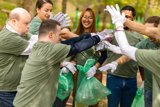 istock Volunteers joining hands after successfully cleaning a forest 1533470399