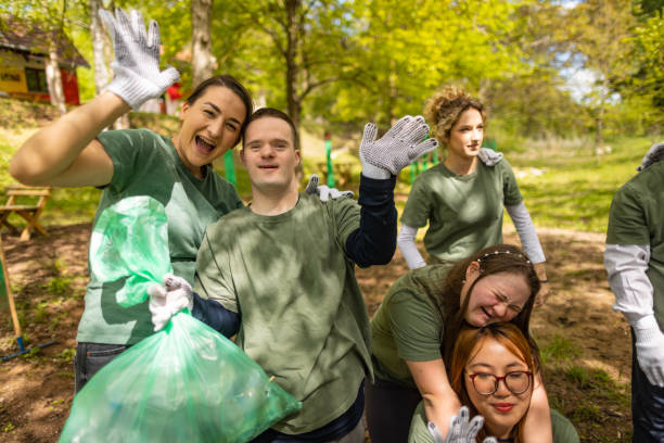 istock Volunteers waving to camera after cleaning up a forest 1533472463