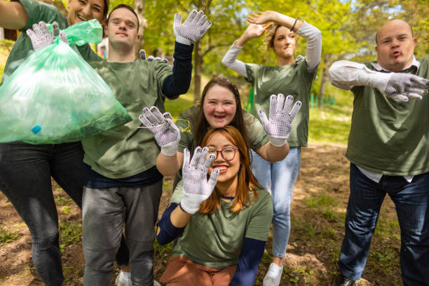 istock Volunteers waving to camera after cleaning up a forest 1533472464