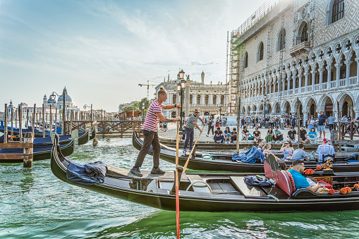 Venice, Italy - May 29 2023: Traditional gondola ride on the Grand Canal.Tourists in Venice.