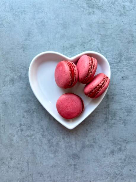 istock Pink macaroons on a heart-shaped saucer. Valentine's Day. 1533475598