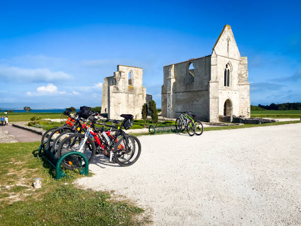 Bicycles parked in front of the Abbaye des Chateliers in La Flotte Bicycles parked in front of the Abbaye des Chateliers in La Flotte, France flotte stock pictures, royalty-free photos & images