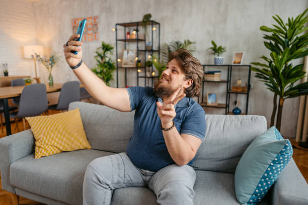 istock Young Man Taking Selfies At Home 1533512978