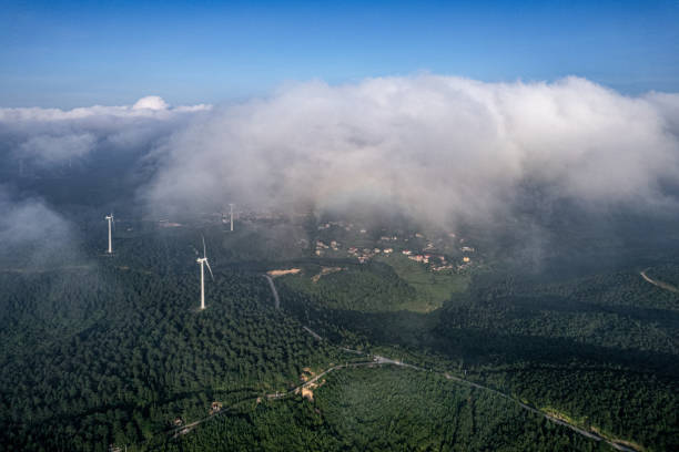 istock Village in Cloudy Mountain and Wind Turbines 1533514572