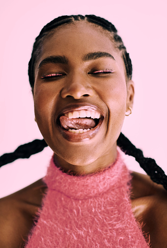 Vibrant and expressive black woman wearing pink. Stock photo