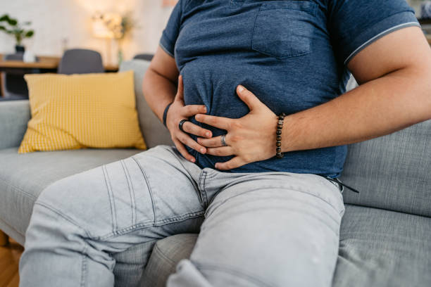 istock Young Man Having Stomach Pain At Home 1533527418