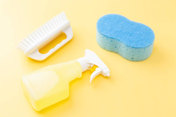 istock Cleaning supplies on yellow background 1533588685