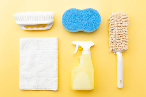 istock Cleaning supplies on yellow background 1533595170
