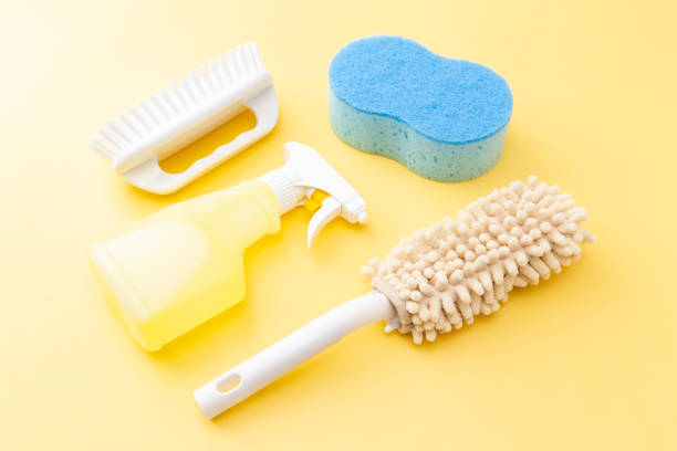 istock Cleaning supplies on yellow background 1533595641