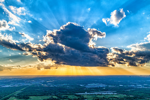 Blue and orange sunset sky with rays of sun. Natural landscape for background