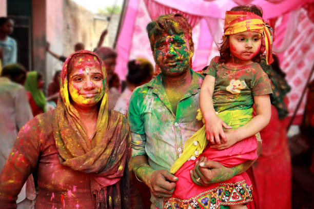 Family celebrating Holi festival stock photo