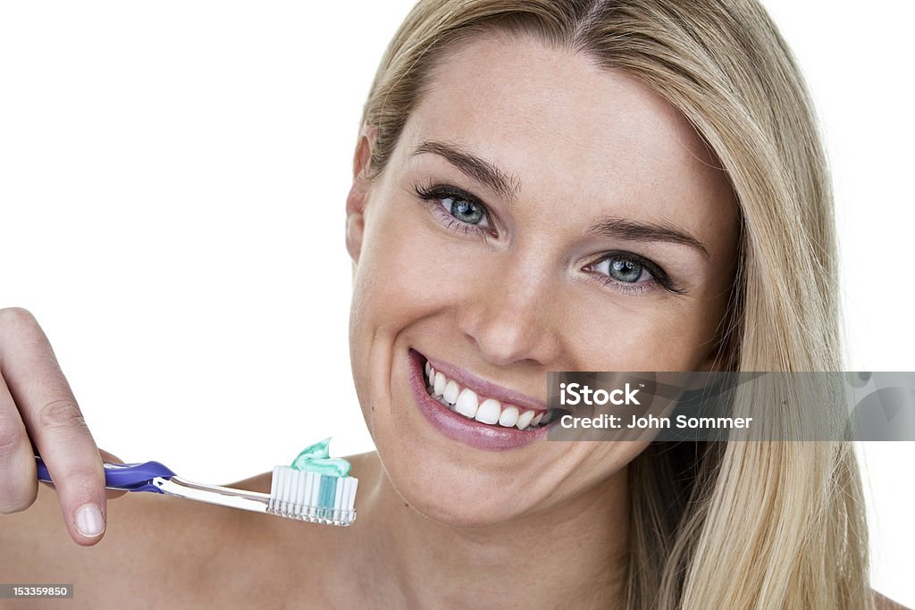 Woman cleaning teeth Beautiful woman with toothbrush and perfect smile isolated on white background  20-24 Years Stock Photo