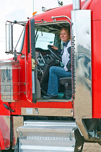 istock Interior view of big rig with woman driver 153360086