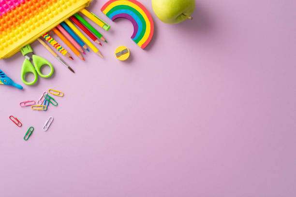 istock Immerse in joy of learning for young learners through this top view snapshot: a vibrant compilation of child stationery against violet isolated background, providing copyspace for text or promotion 1533604030