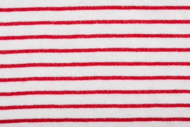 istock Red and white stripes. Striped red and white textile pattern as a background. Close up on vertical stripes material texture fabric. 1533606209