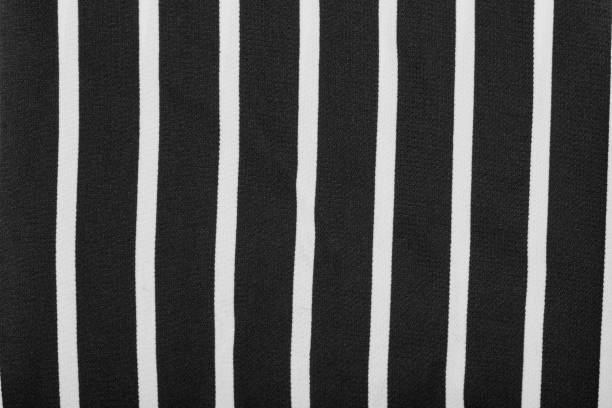 Black and white stripes. Striped black and white textile pattern as a background. Close up on vertical stripes material texture fabric.