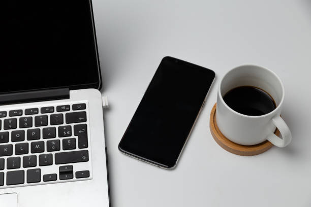 istock close up of smartphone, laptop, note, and coffee cup 1533610609