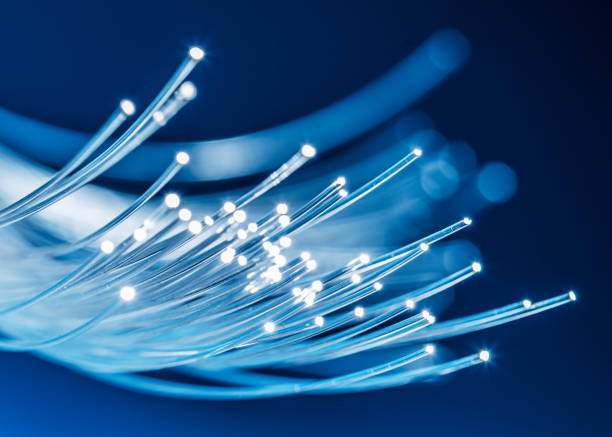 istock Bundle of optical fibers with lights in the ends. Blue background. 1533626838