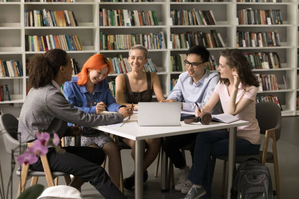 istock Happy trendy classmates doing school homework in library 1533628553