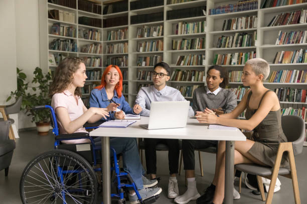 istock Multiethnic team of students inclusively classmate with disability studying together 1533629655