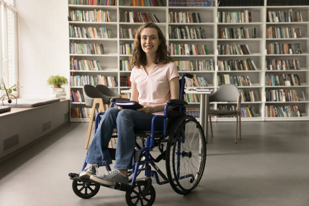 istock Cheerful young college student with disability using wheelchair 1533629660