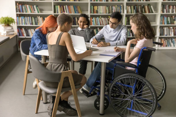 istock Students inclusively college mate with disability sitting at table 1533629890