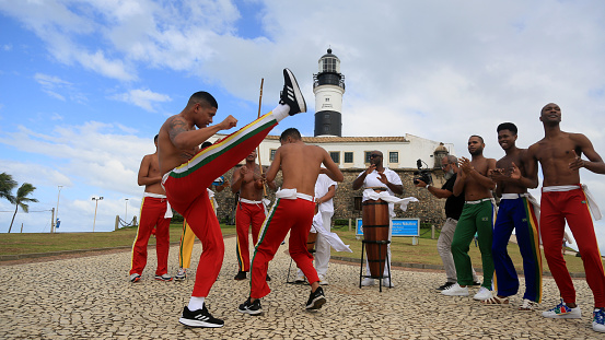 salvador, bahia, brazil - july 4, 2023: capoeiristas perform at Farol da Barra during the launch of the Chinese automaker BYD factory, which will open a factory in the city of Camacari.