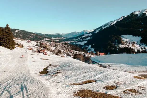 Scenic view of snow coverd Hirschegg at ski region of  Kleinwalsertal, Austria in winter against blue sky